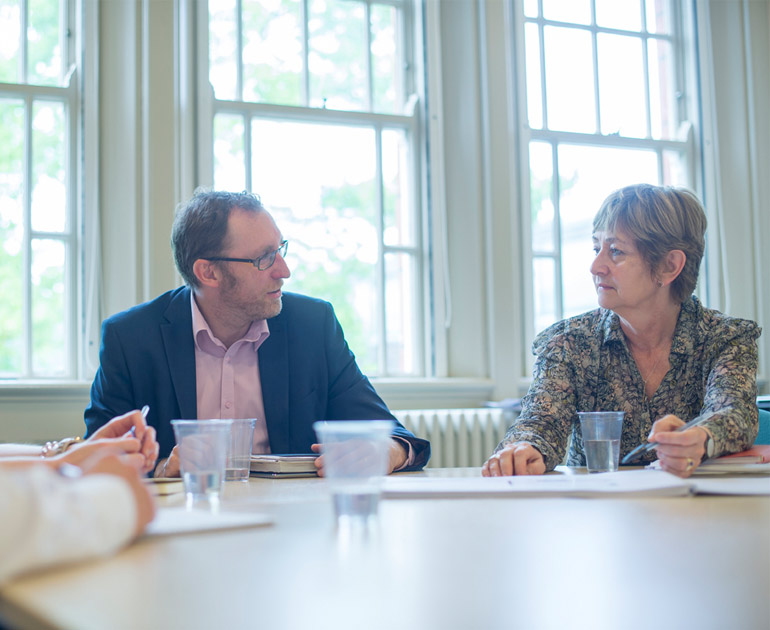 A man and a woman discussing business in the Seminar Room, one of our rooms for hire.
