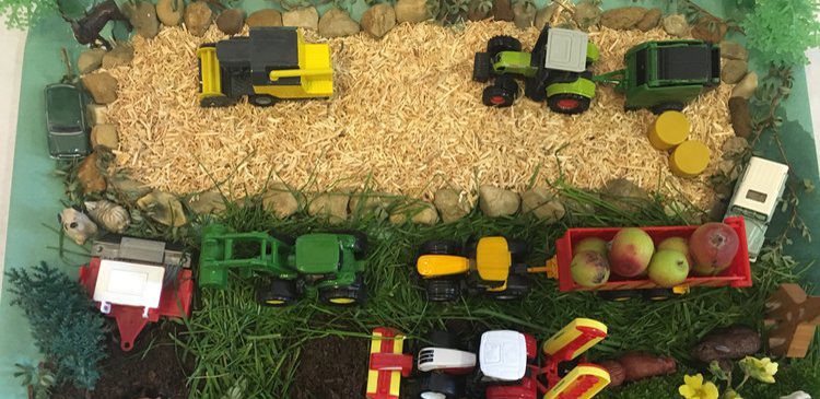 Aerial view of farming scene with toy tractors