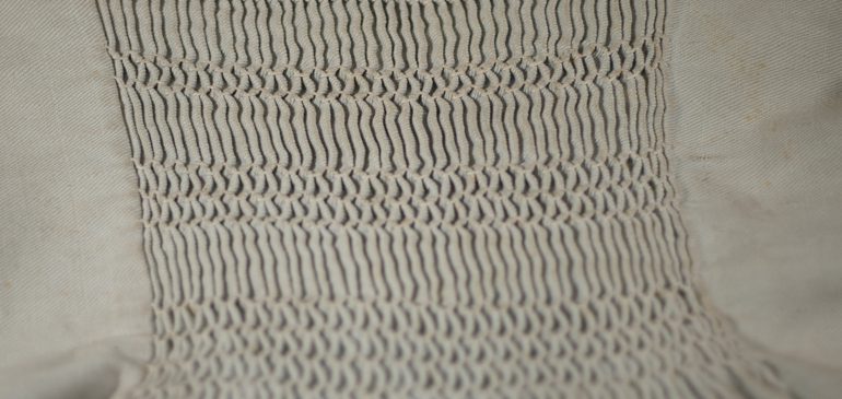 A close-up of smocking stitch on a smock from the MERL collection