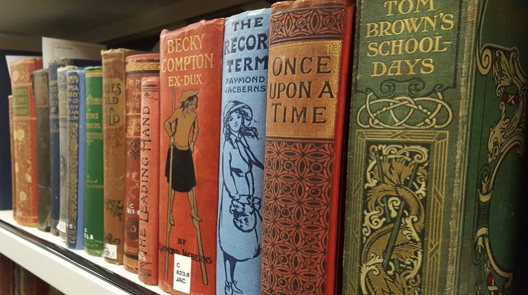 Row of books on a shelf seen from an angle