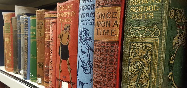 Row of books on a shelf seen from an angle