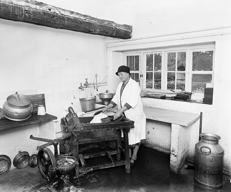 Woman making butter in the Little Dairy, at the farm of Mrs Spottiswood, Berkshire