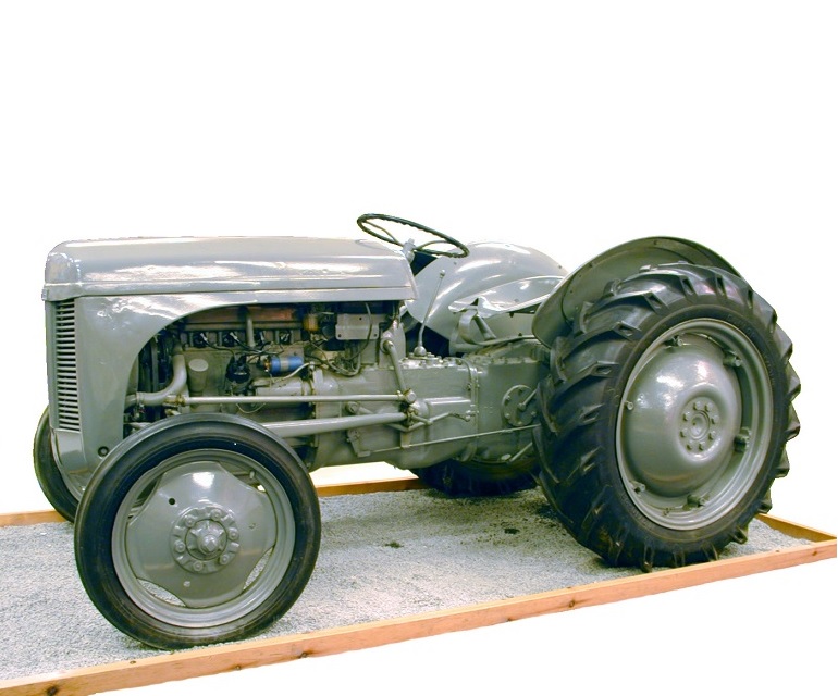 A grey Ferguson tractor on a low pedestal.