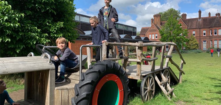 Children playing on the tractor in the MERL garden for innovations science workshop