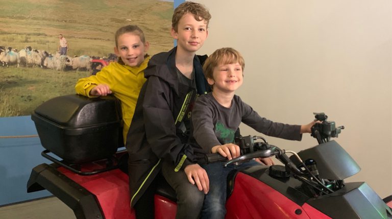Children sitting on the quad bike at the MERL for the Virtual Reality experience