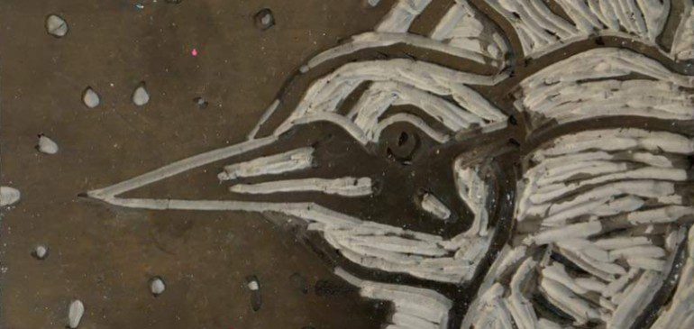 Lino print block of a bird in profile