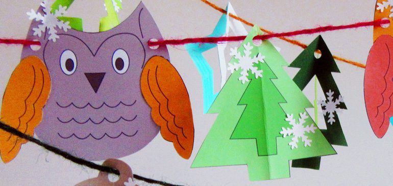 A colourful paper owl and christmas tree deocrated with snowflakes as part of a garland to make at the Second Sunday craft drop-in