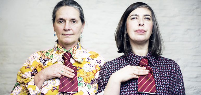 Sheila Ghelani & Sue Palmer wearing brightly coloured shirts and stripy ties which have been cut off, from Common Salt
