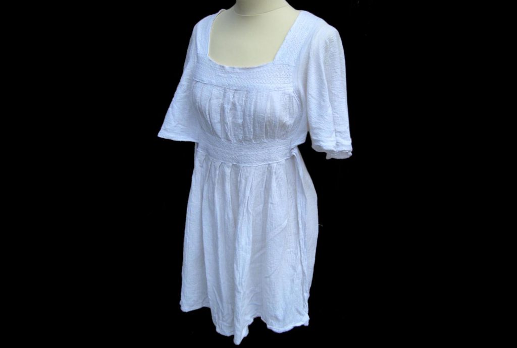 White dress with smock style design to the front