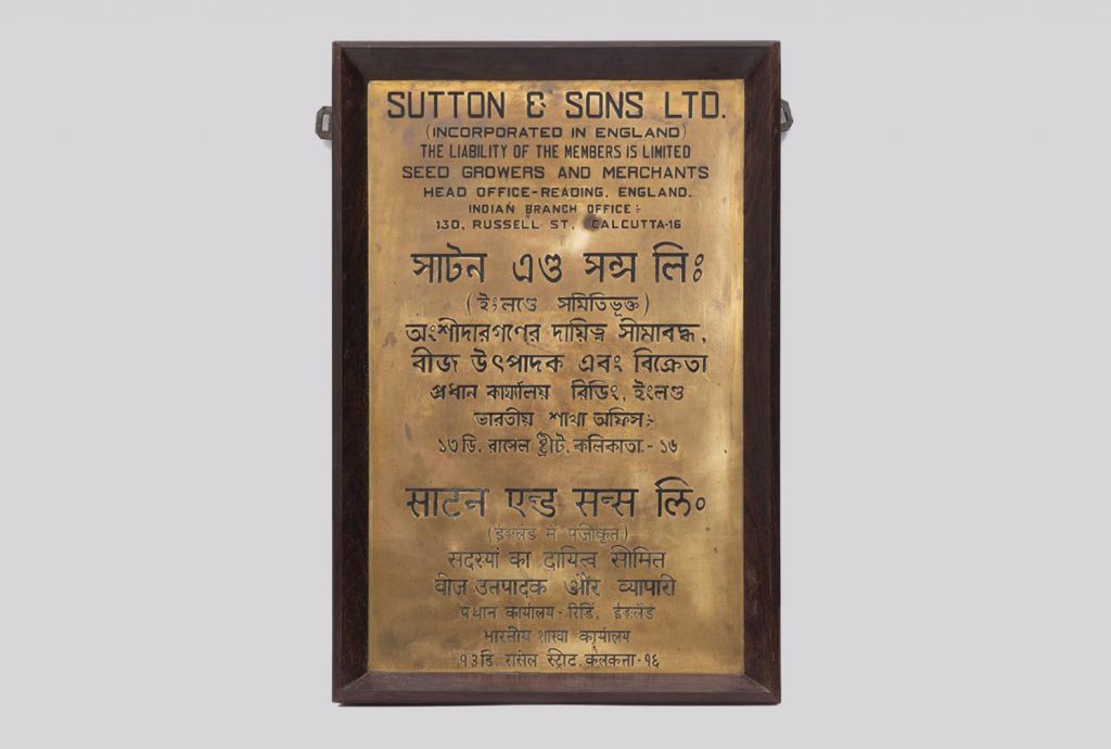 A brass plaque with text in different scripts