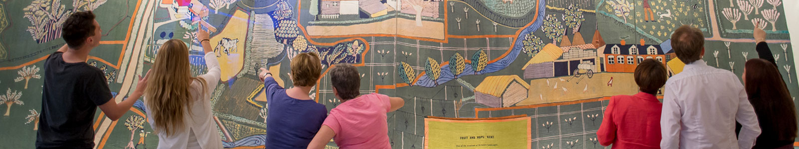 People on a group visit to the MERL looking at the O'Connell wall-hanging