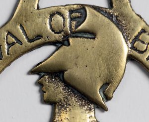 Detail of Armac Brassworks, Festival of Britain horse brass showing helmeted head of Britannia