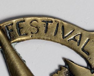Detail of Armac Brassworks, Festival of Britain horse brass showing the word 'Festival'