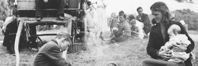 Black and white photograph of a family of gypsies taken by John Tarlton in Essex, likely in the 1950s.