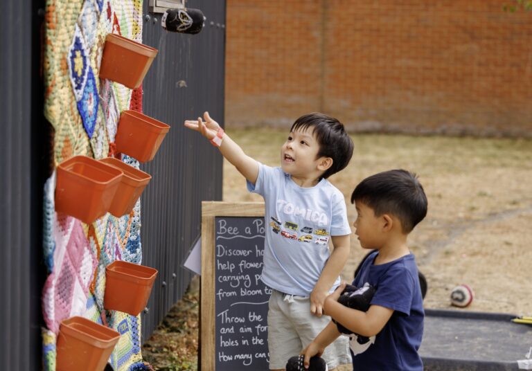 2 boys playing a game in the MERL garden