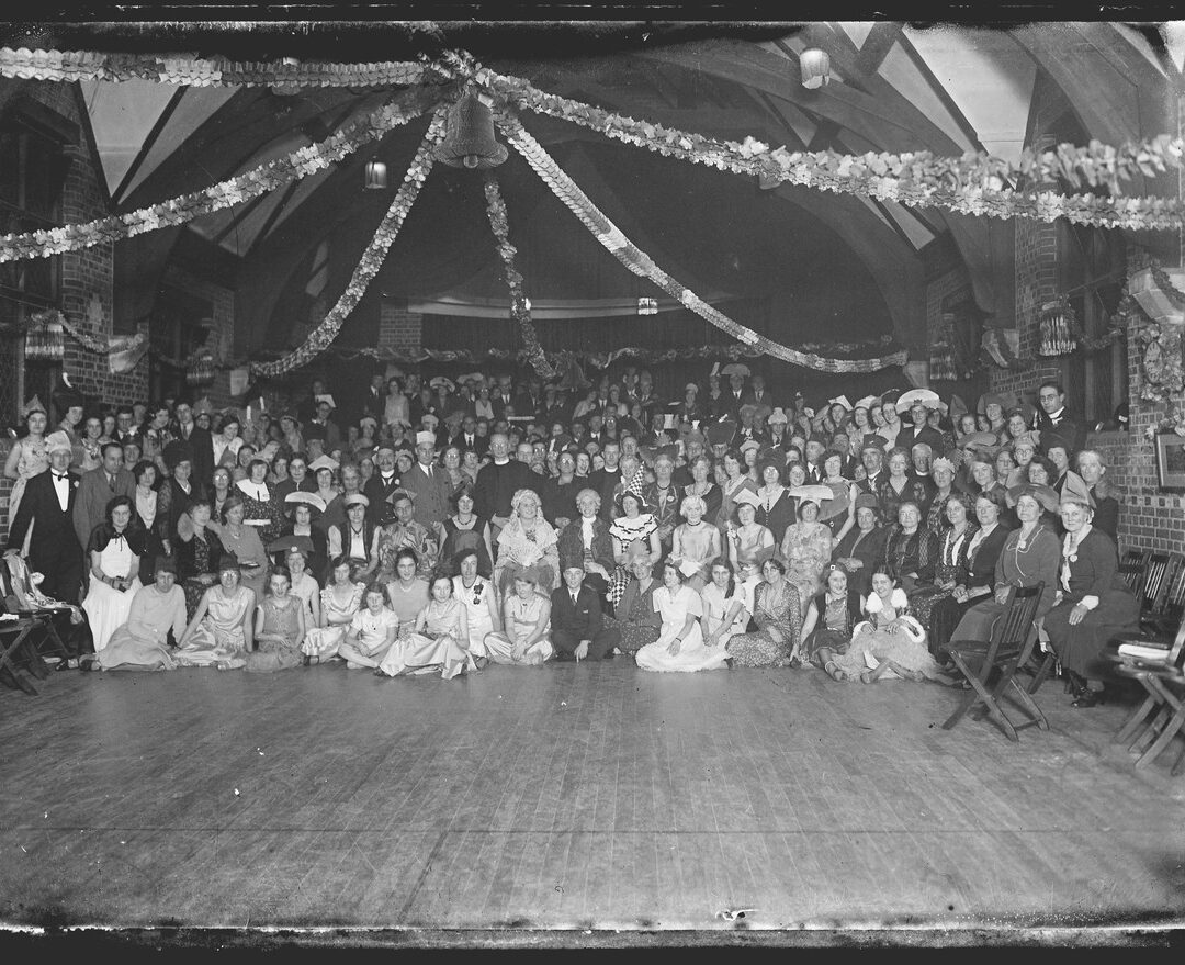 Black and white photographic negative of a Christmas party Servants’ Christmas parties were usually held in their dining hall, as it was large enough to accommodate dancing, instruments and food. (P DX323 PH1/M18/7)