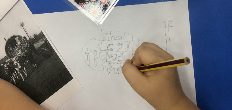Child drawing from a picture of a vardo in pencil