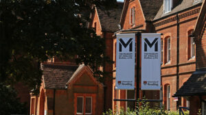 Banners with the MERL logo in front of a Victorian brick building, East Thorpe