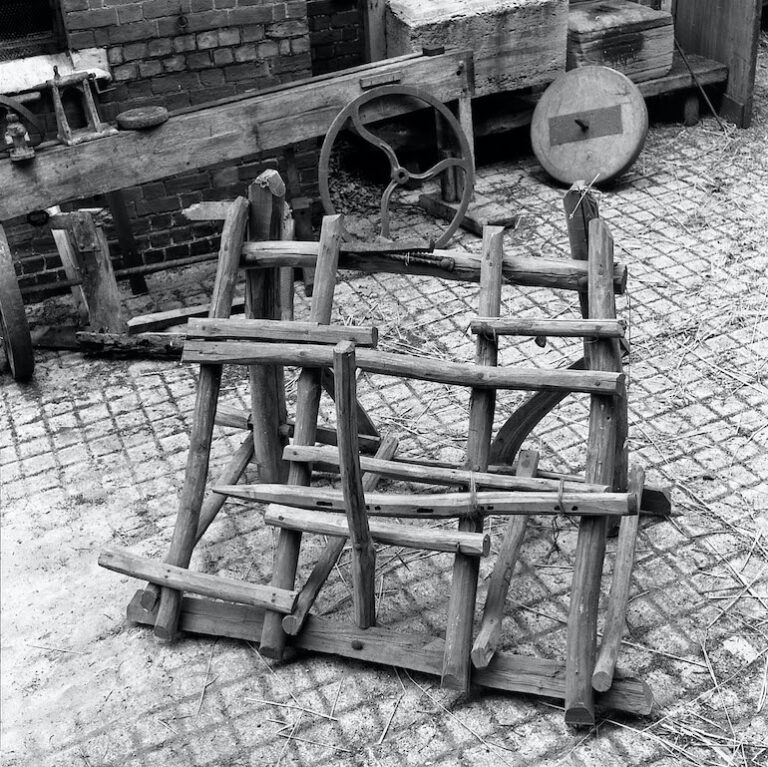 This brake was used by a hurdlemaker when making wooden gate hurdles. It consists of a complex wooden frame supporting a toothed iron jaw. It was acquired from the 1951 Festival of Britain. Hurdle maker's brake (MERL 52/36)