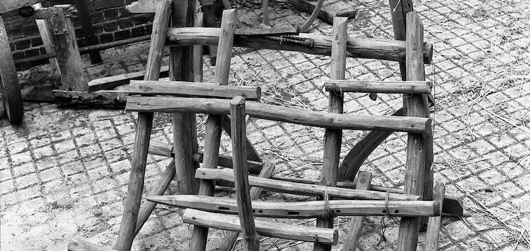 This brake was used by a hurdlemaker when making wooden gate hurdles. It consists of a complex wooden frame supporting a toothed iron jaw. It was acquired from the 1951 Festival of Britain. Hurdle maker's brake (MERL 52/36)