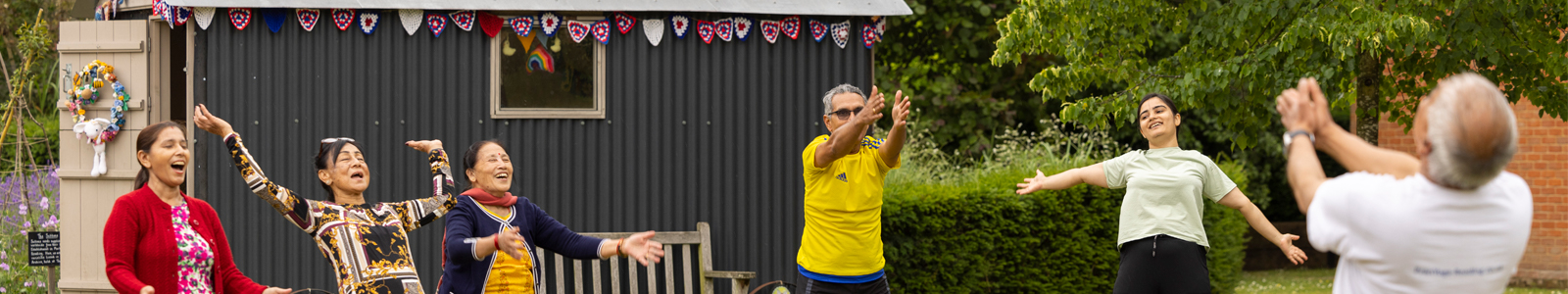 A group practices yoga in The MERL garden.