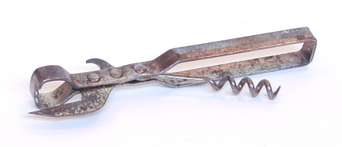 Tin opener (object name) This is a multi-task metal tin opener with a silver finish which has worn off with use. In addition to the tin opener blade, it also has a bottle opener hook and a corkscrew in the handle.