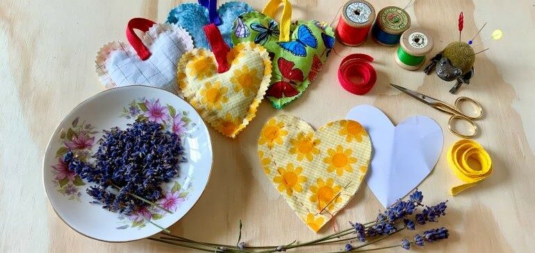 Craft materials and lavender lying on a table.