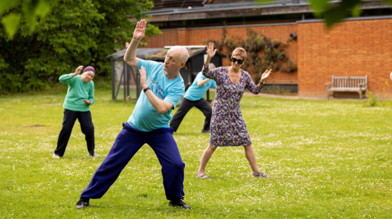 People taking part in a Tai Chi session in The MERL garden