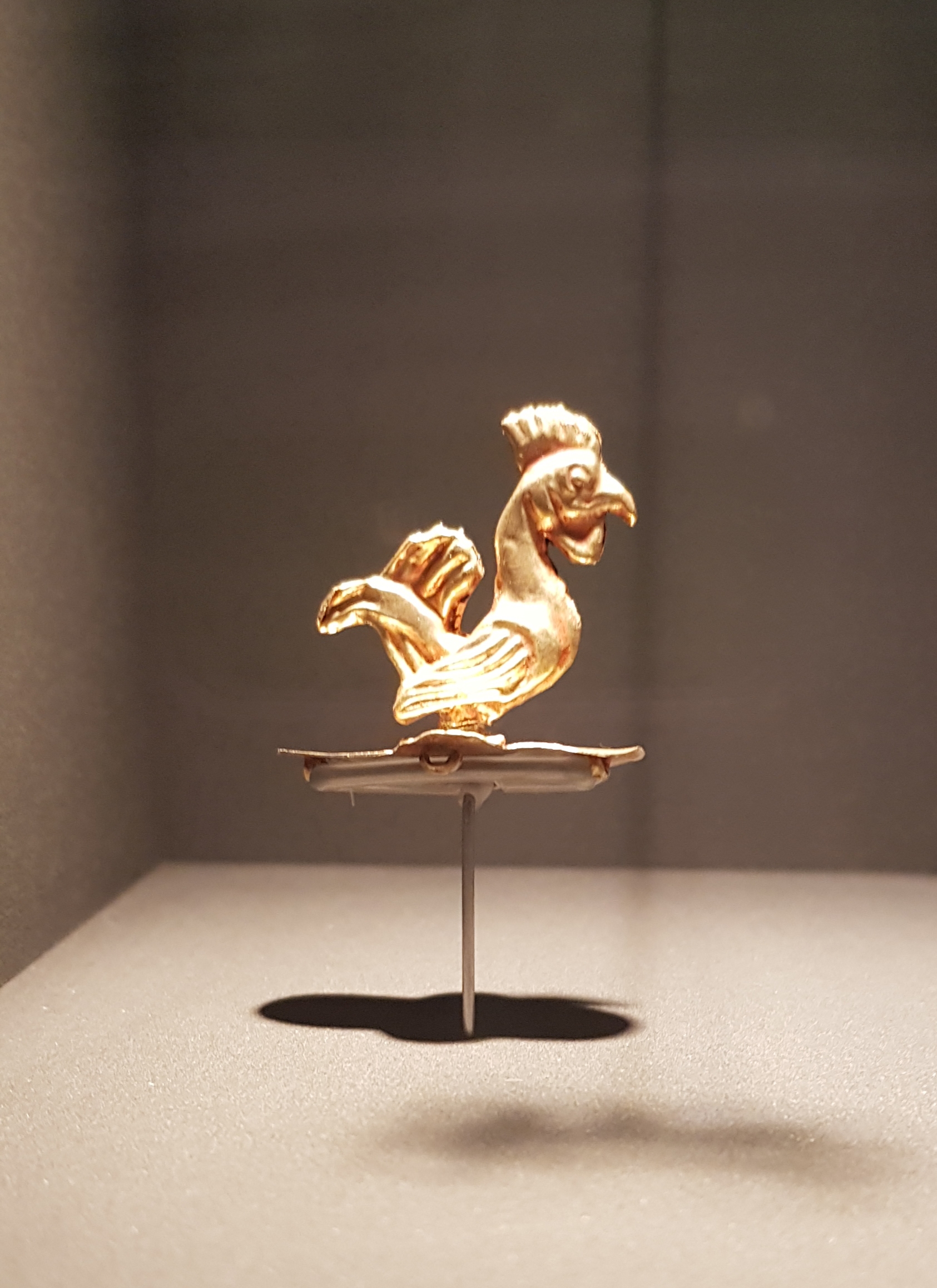 A miniature golden figurine of a rooster at the Kyrgyz State History Museum in Bishkek.