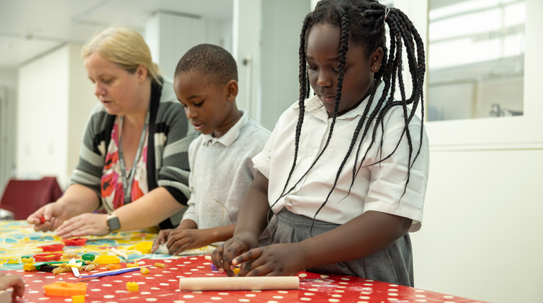 School kids making biscuits.