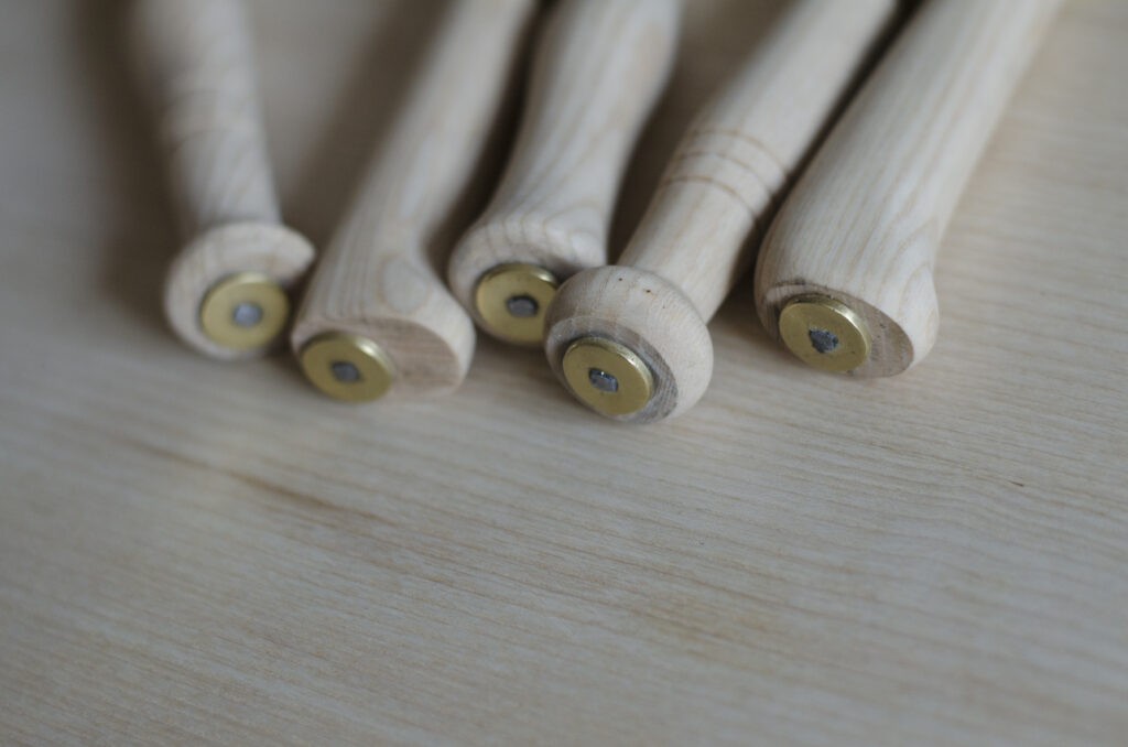 Detail showing domestic pruning knives inspired by billhooks sitting on a table top surface.