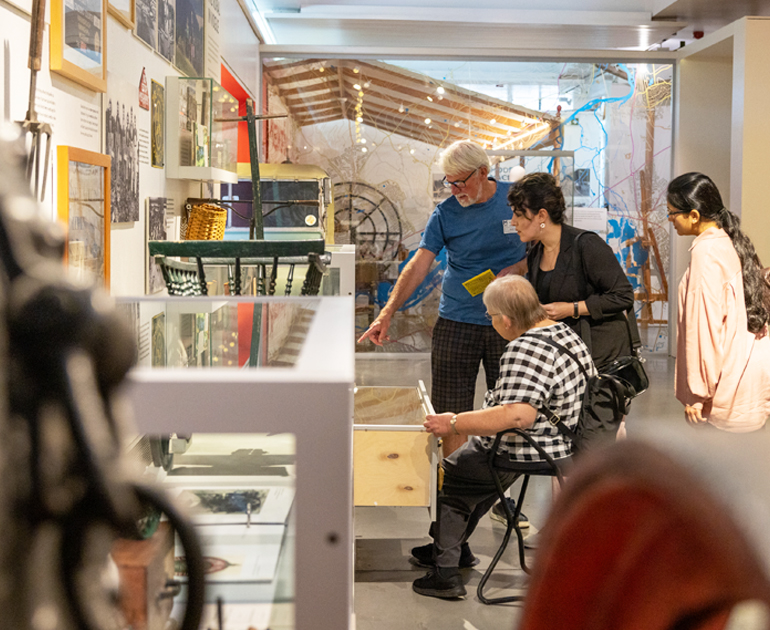 a small group looking at a display in the MERL galleries