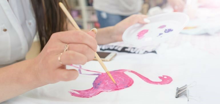 Woman painting a picture of a flamingo