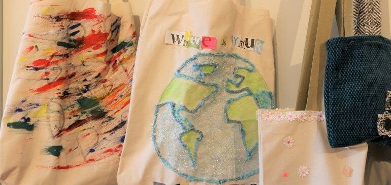 Tote bags hanging up in the Sew What exhibition