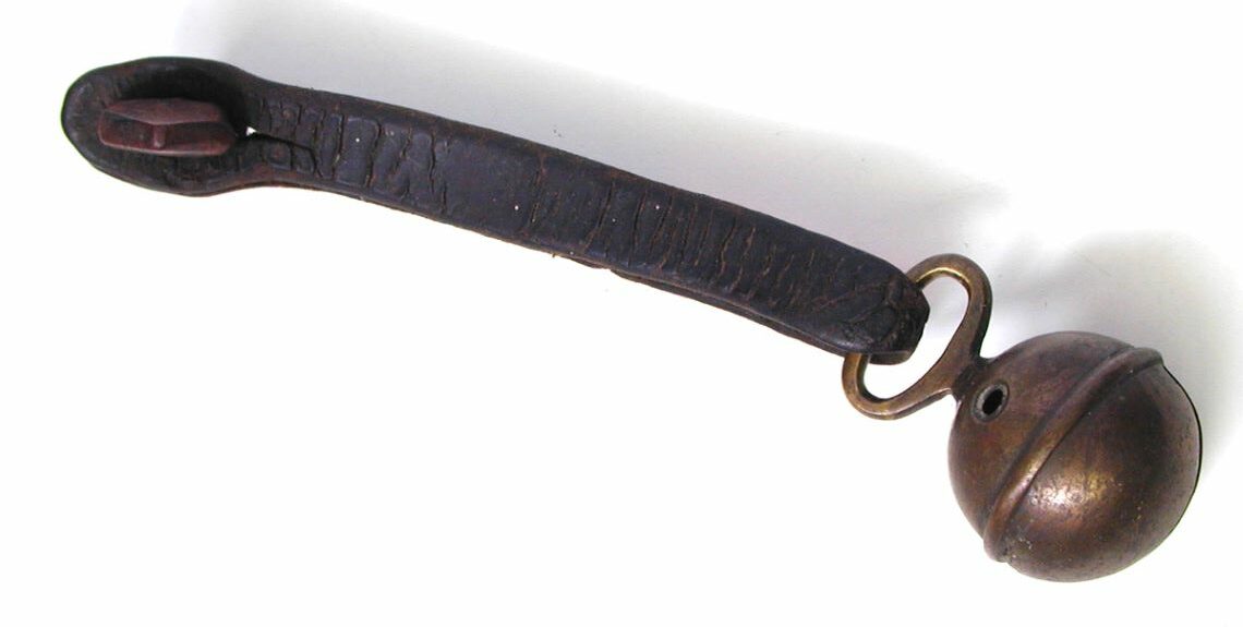 Image of a goat bell with leather strap