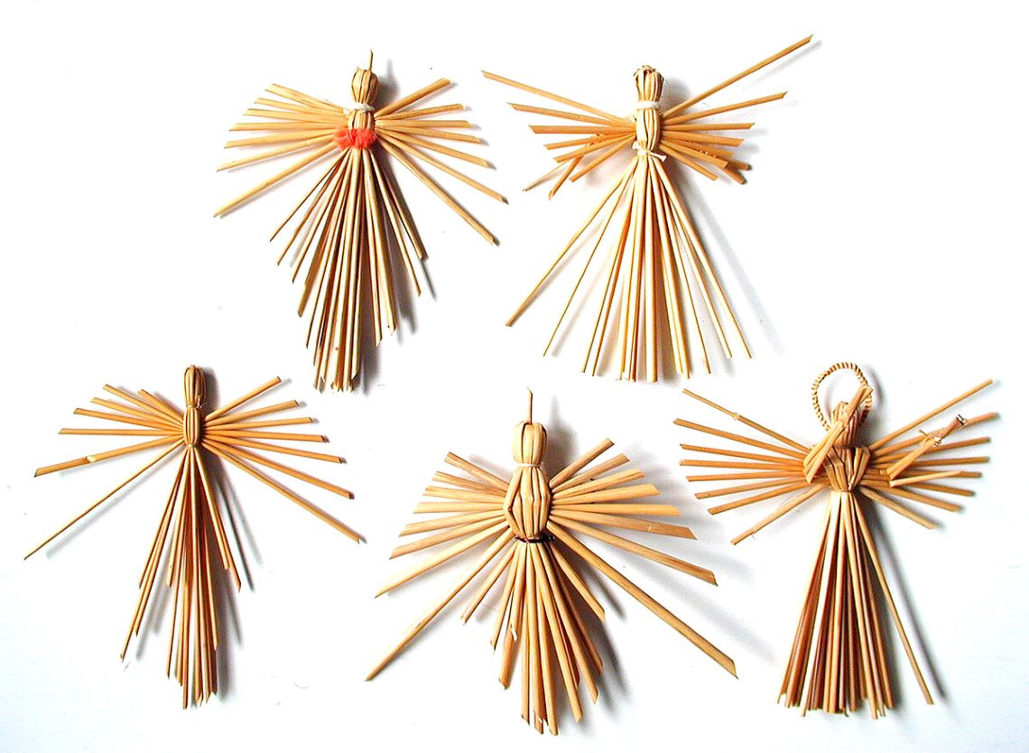 Five angel figures crafted from straw
