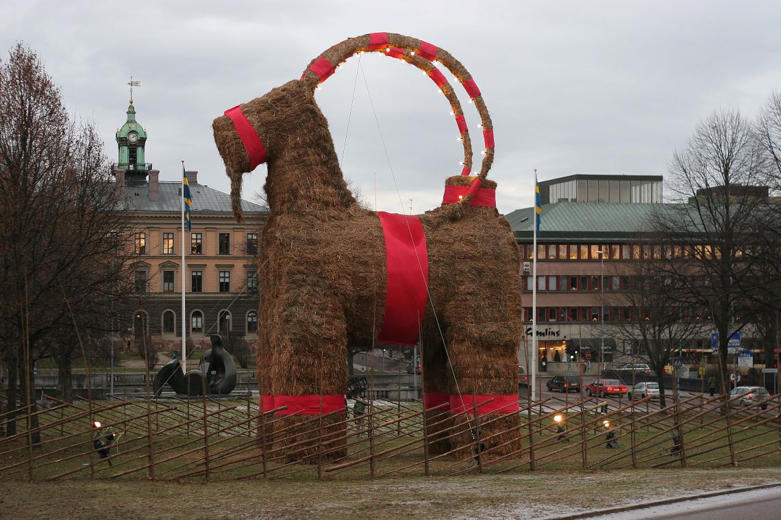 A large straw goat standing in a field
