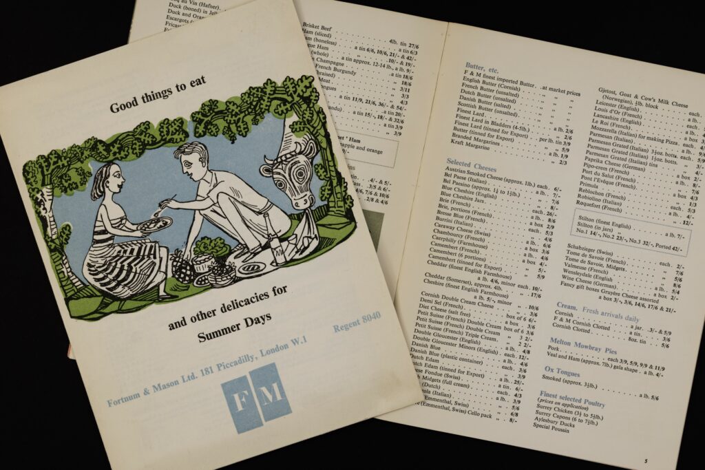 Sale catalogue issued by the London store Fortnum and Mason featuring a couple enjoying a picnic and listing a variety of cheeses available for sale