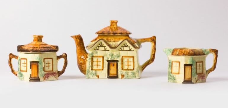 Three teapots from the MERL collection, modeled after cottages