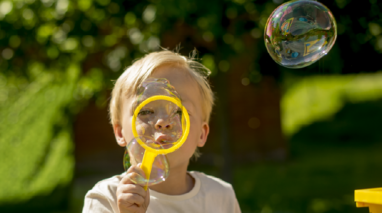 A boy blows a bubble at The MERL
