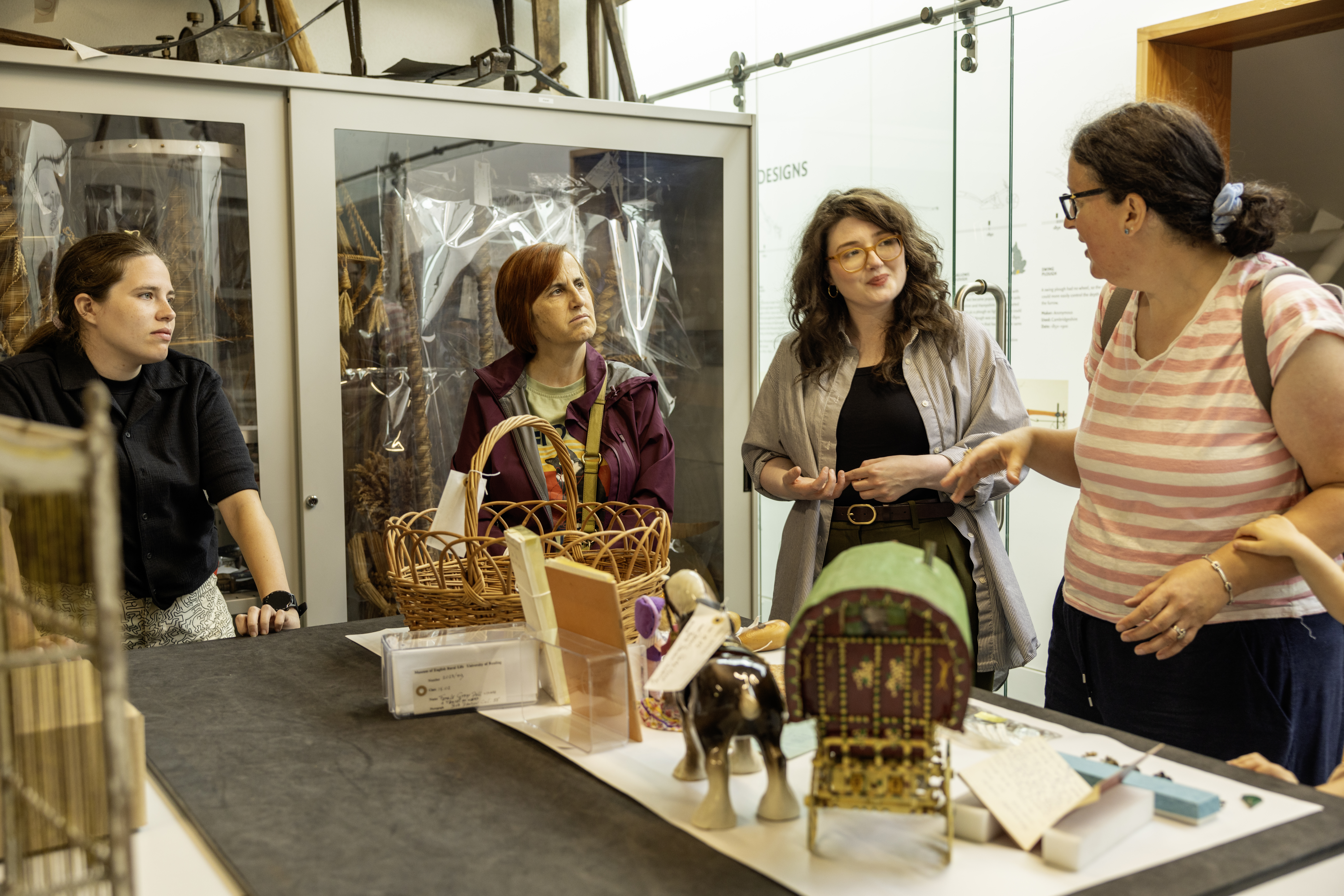 People in The MERL looking at objects related to Gypsy, Roma and Traveller histories.