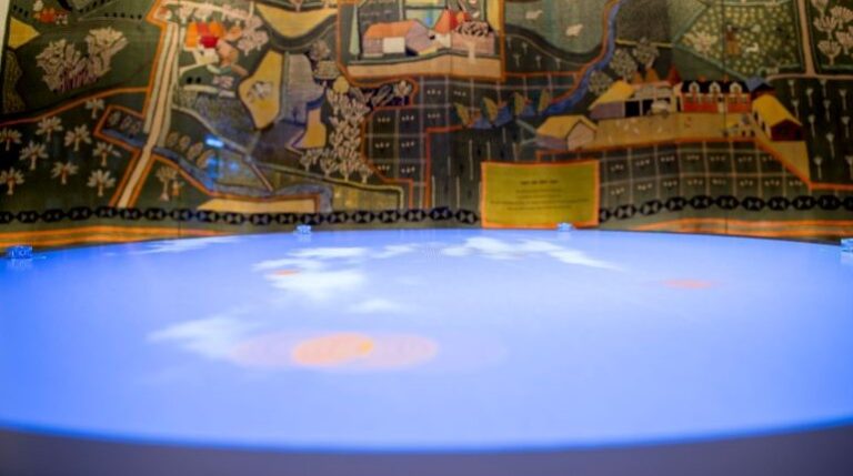 View of the interactive table and wall hanging in the Our Country Lives gallery at The MERL