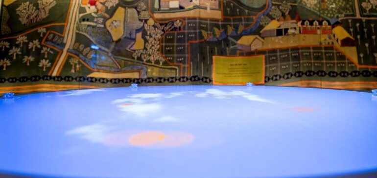 View of the interactive table and wall hanging in the Our Country Lives gallery at The MERL