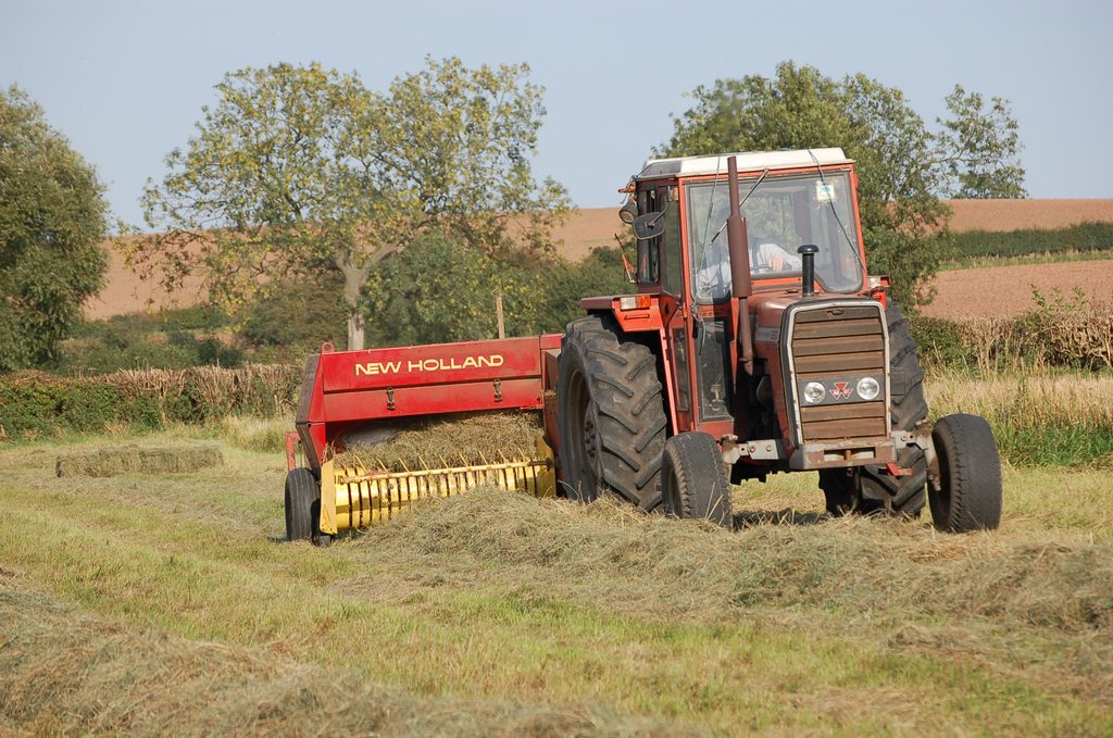 A man drives a tractor in a field
