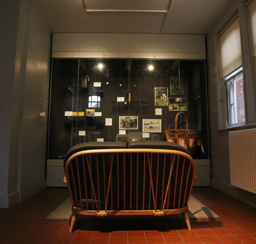 A photo showing the whole of the Wellbeing in the Countryside display with a sofa in front of it.