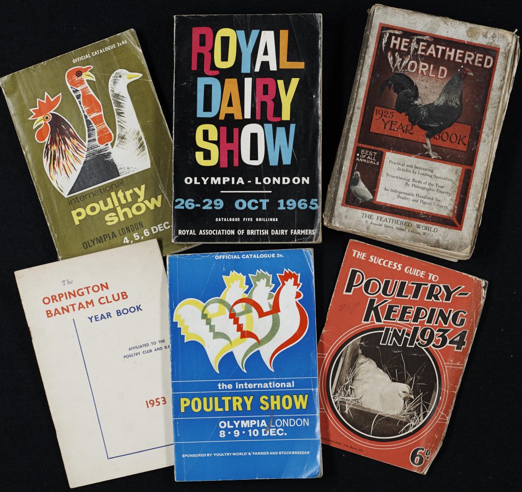 A selection of books from the Burdett collection in the Poultry Archive. All are books from the 1950s and 1960s lying on a black background.