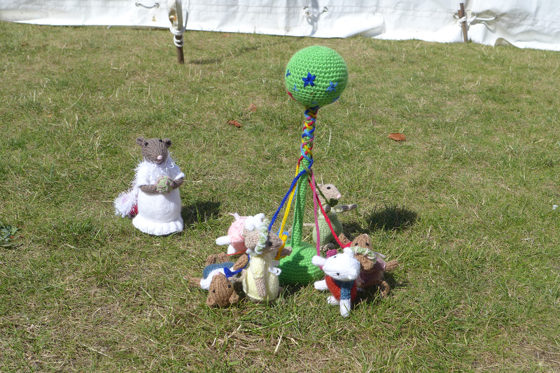 A troupe of knitted mice dancing round a maypole
