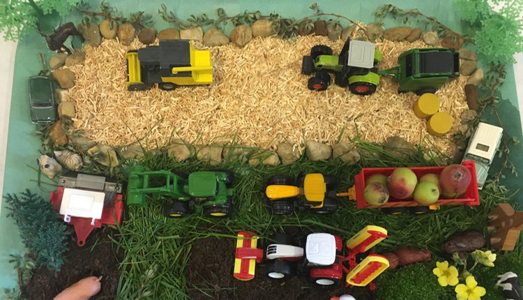 Aerial view of farming scene with toy tractors
