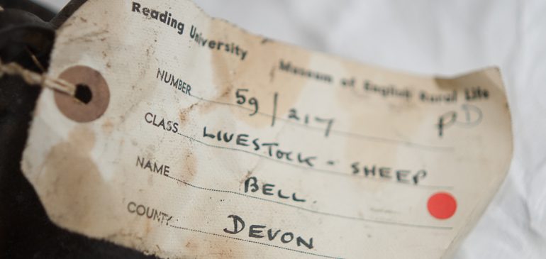 A hand-written object label for a sheep bell from Devon