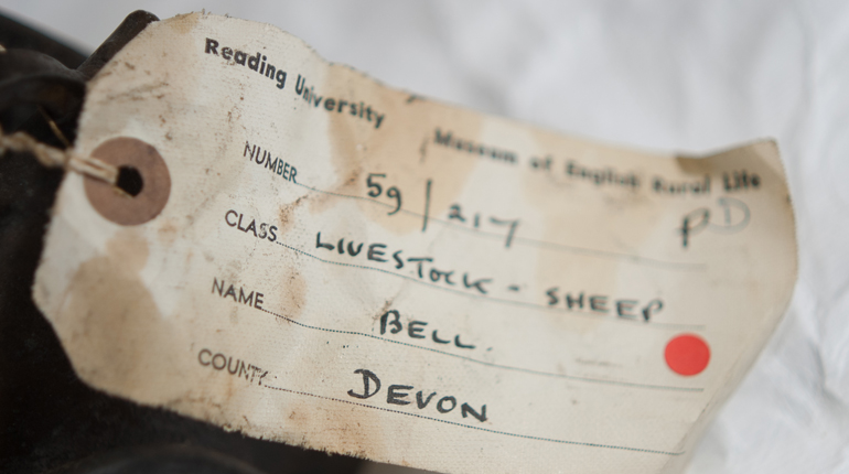 A hand-written object label for a sheep bell from Devon